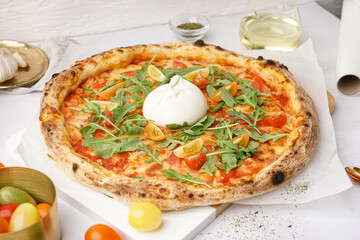 Tasty pizza with Burrata cheese on white background