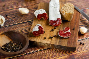 Marble cutting board with sliced salami on it