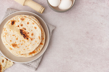 Plate of tasty pita bread on white background