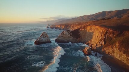 Sunset coastal cliffs with ocean waves crashing.