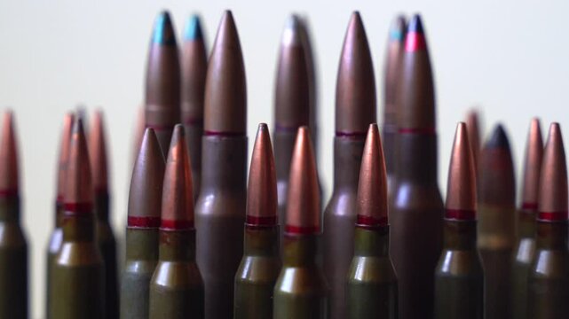 Different types of different types of bullets close-up rotating on white background, shallow depth of field