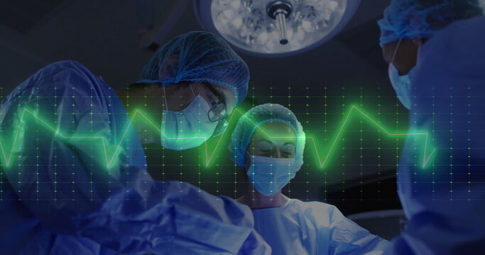 Image of cardiograph over diverse surgeons during surgery