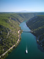 Cruise boat sails in the river canyon in Krka National Park, Croatia