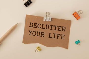 DECLUTTER YOUR LIFE text concept write on a notebook on wooden background.