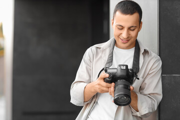 Male photographer with modern camera outdoors