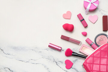 Cosmetic bag with makeup products and gift box on white background. Valentine's day celebration