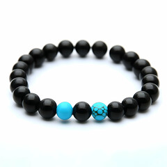 Obraz premium Black and turquoise beaded bracelet on white