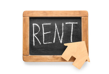 Toy house and word RENT on chalkboard against white background