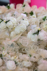 A basket containing flowers for decorating guests at a wedding