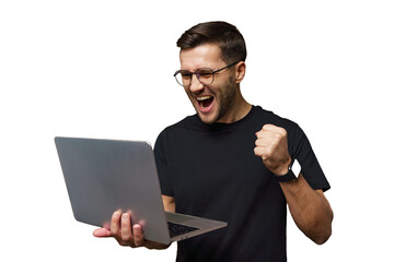 Excited young man celebrates success while working on a laptop at home