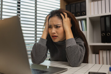 exhausted young woman with laptop in her home office, businesswoman, stress in office for project deadline, brain fog and frustrated with overtime, fatigue and overwhelmed for administration