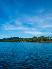Photography landscape beautiful summer season vertical look view island horizon tropical shore open sea cloud clean blue sky background calm nature ocean wave water nobody travel at sun day time