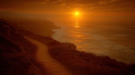Serene coastal sunset over rocky cliffs with a winding path leading to the ocean