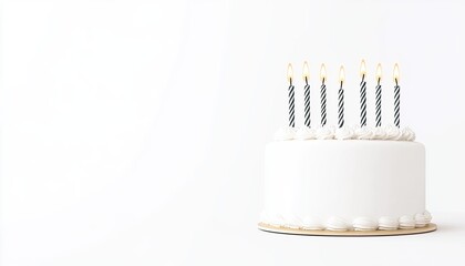 A beautifully decorated white birthday cake with nine lit candles on top, set against a plain background