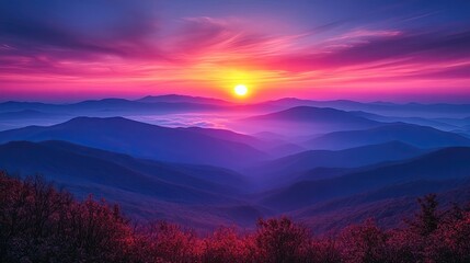 Fototapeta premium Majestic sunset over rolling mountains with vibrant colors and mist in the valleys below