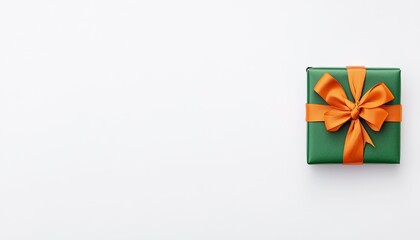 A beautifully wrapped green gift box with an orange ribbon on a clean white background