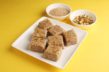 Sesame seed jaggery , pistachios barfi or til ke gul pistachios  
   barfi and tilgul or til gul,pistachios  barfi  served for Makar  Sankranti Festival in India