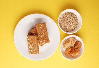 Sesame seed jaggery barfi or til ke gul   barfi and tilgul or til gul barfi 
 served in bowl for Makar Sankranti Festival in India