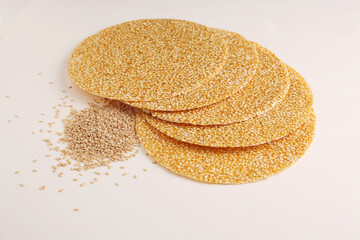 Sesame seed jaggery chikki or til ke chkki and tilgul or til gul ladduchikki served in bowl for Makar Sankranti Festival in India