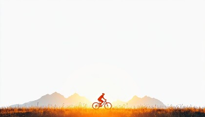 Silhouette of a cyclist riding through golden grasslands at sunset with mountains in the background