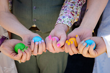 Wedding party holding coloured eggs matching their painted nails