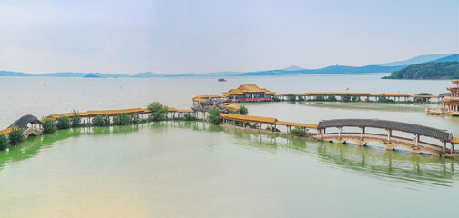 Fototapeta premium An ancient building complex and sunset scenery on the Taihu Lake Lake in Wuxi, Jiangsu Province, China will be on June 3, 2024