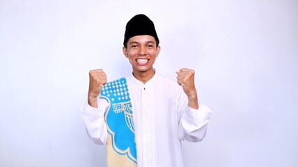 excited handsome young asian muslim man gestures raising his hand with isolated white background