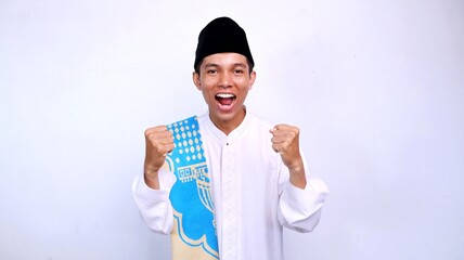 excited handsome young asian muslim man gestures raising his hand with isolated white background