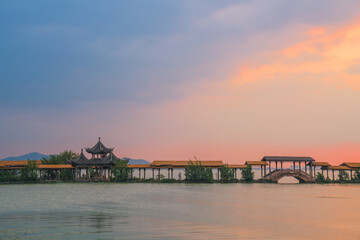Fototapeta premium An ancient building complex and sunset scenery on the Taihu Lake Lake in Wuxi, Jiangsu Province, China will be on June 3, 2024