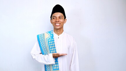 handsome asian muslim young man excited pose showing open palms and looking sideways for promotion, product and discount. recommend something with isolated white background