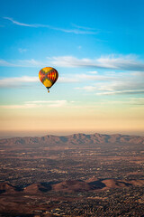 Colorful pattern hot air balloon in the skies over the Phoenix Arizona Sonoran Desert. Photo taken on a clear day