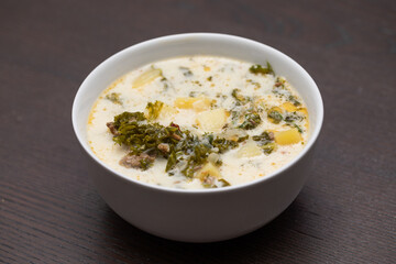 a bowl of Zuppa Toscana Soup on a table