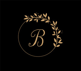 The logo has an elegant and classic design, with the main element being a monogram of the initials, such as the letters A and B, written using a calligraphy or serif font with fine details. The gold c
