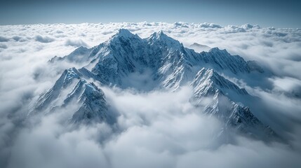 Obraz premium Snowy mountain peaks above clouds; aerial view