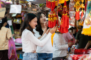 Young Asian female Friends Exploring and buys Festive Decorate chinese new year