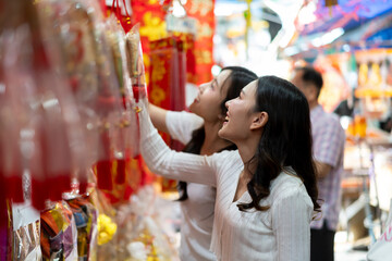 Young Asian Women Shopping for Traditional Offerings Outdoors