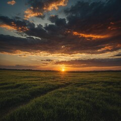 A wide open plain with a dramatic sunset painting the sky.