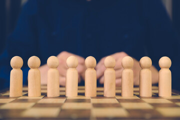 Person wooden doll standing leader from group teamwork people for HR human resources officer or business planning relationship or team player and personnel management job performance.