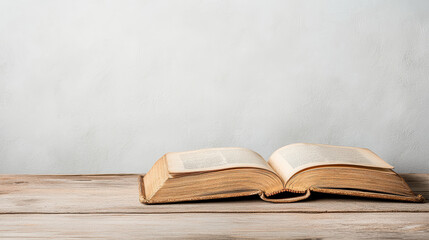 Fototapeta premium weathered old book lying open on wooden table, evoking nostalgia
