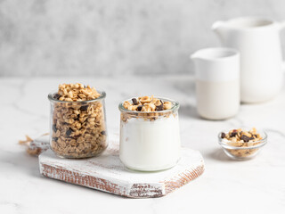 granola with chocolate, yogurt with granola in a glass jar