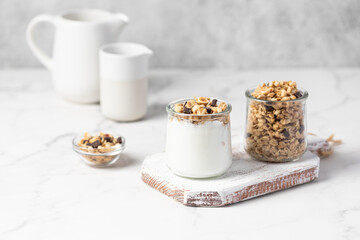 granola with chocolate, yogurt with granola in a glass jar