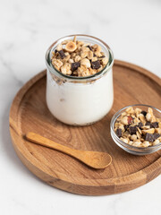 granola with chocolate, yogurt with granola in a glass jar