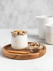 granola with chocolate, yogurt with granola in a glass jar