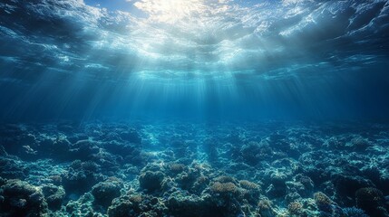 Obraz premium Sunbeams illuminate the ocean floor, revealing a vibrant coral reef ecosystem.