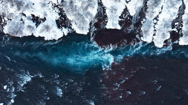 Pure turquoise water, glacial river with huge current, Waterfall in Iceland, Frozen waterfall in winter, magical winter location of snow and ice, Popular tourist attraction