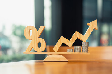 Coins stack and Percentage model on wood balance. Concepts for methods, systems of raising or...