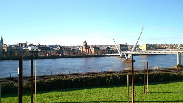 Aerial shot of the Peace Bridge in Derry-Londonderry, NI. Beginning at Ebrington Park, the camera advances to show the bridge. Filmed in 4K at 60fps and in Rec709 color space.