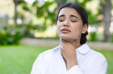 Allergic ill south asian Indian woman getting sick and having sore throat, coughing, air pollution allergy or choking with sickness or flu inflammatory infection