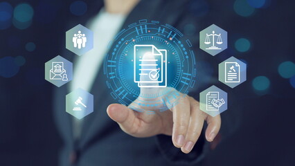 Businessman touch compliance icons on virtual screen for enforcement of laws, regulations, and standards.Compliance rules and law regulation policy concept.