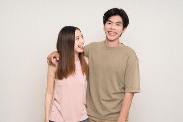 Happy asian couple attractive in various action gesture standing on isolated white background. Cheerful Smiling young man and woman